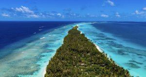 Aerial view of Dhigurah's narrow tip reaching out into the reef